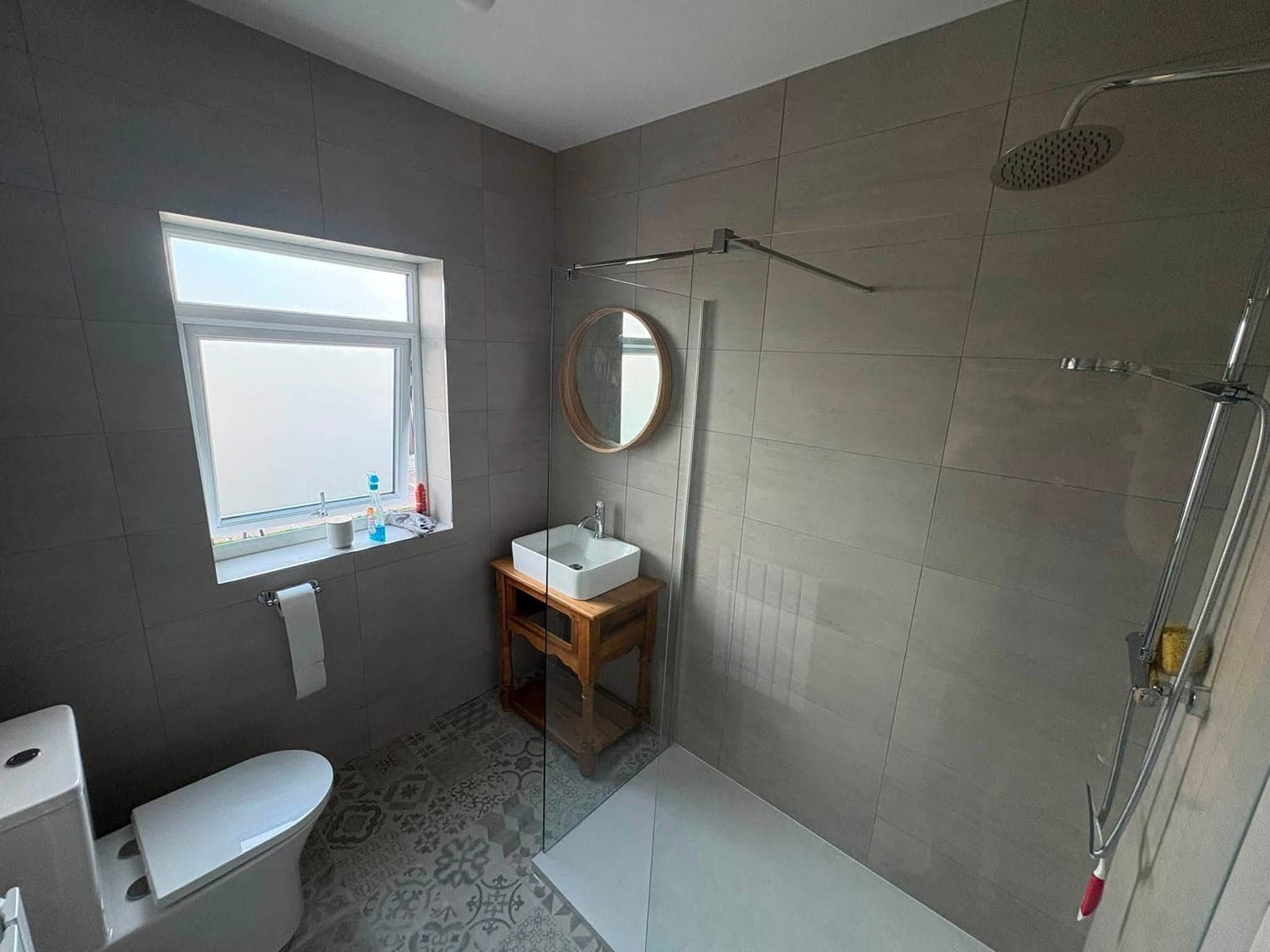 Completed walk-in shower room with glass screen